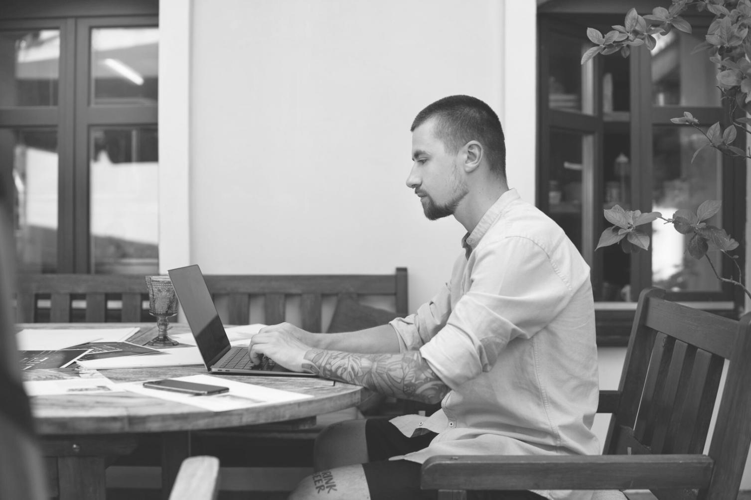 Modern office space with startup team collaborating around a table, reviewing business documents and fundraising materials